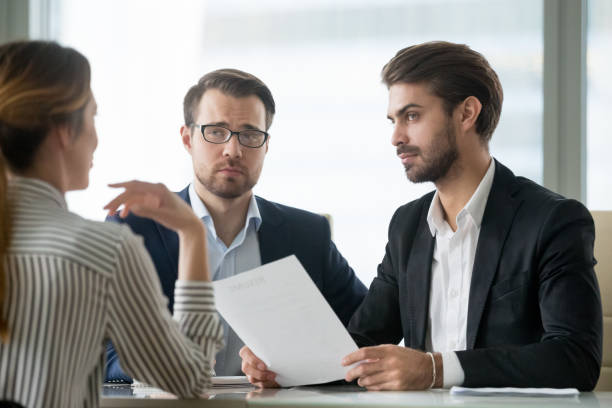 istock Skeptical male hr managers unconvinced about hiring female candidate 1129638632