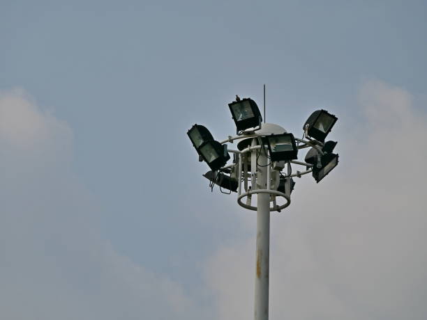 istock Spot light tower in sport stadium on sky 1129638767