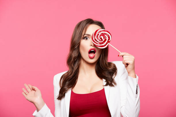 istock Girl posing with lollypop 1129638800
