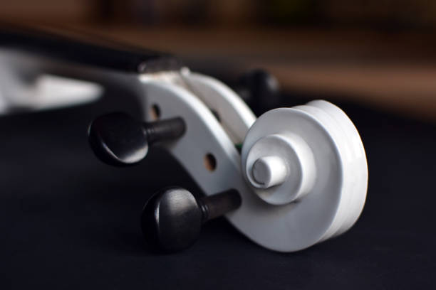 Close up of a violin on the white wooden table