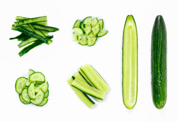 istock Fresh whole and sliced cucumber. Close up. Top view. Isolated on white background 1129640436