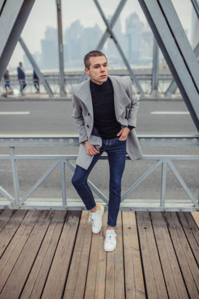 istock Man in gray coat standing on the bridge 1129640493
