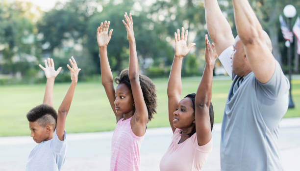 istock Interracial family exercising in park together 1129640647