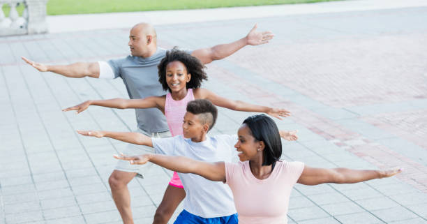 istock Interracial family exercising in park together 1129640795