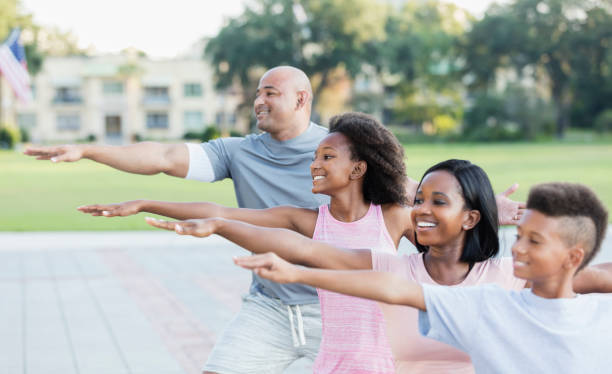 istock Interracial family exercising in park together 1129640797