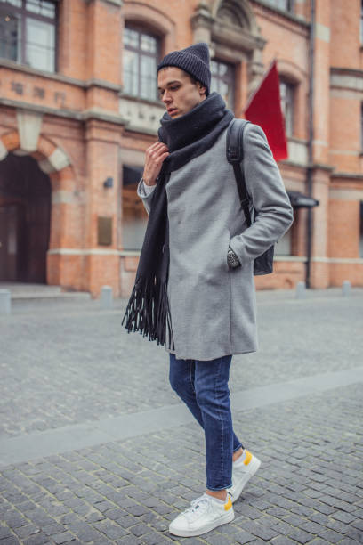 istock Young stylish guy walking on the street 1129642338