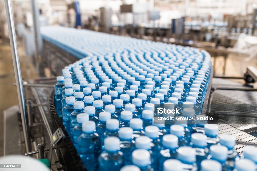 Bottling plant Bottling plant - Water bottling line for processing and bottling carbonated water into bottles. Plastic Stock Photo