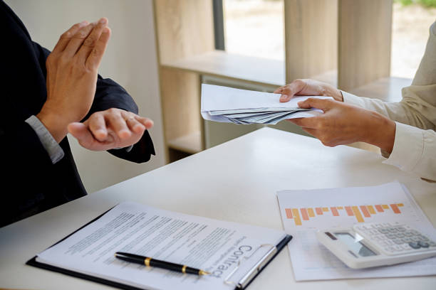 istock Businessman refusing money in the envelope to agreement contract, Bribe and corruption concept 1129642509