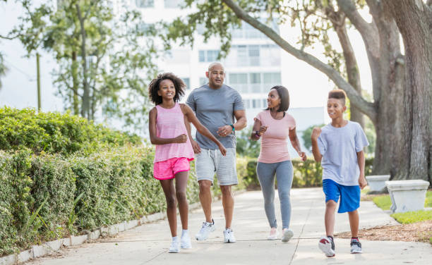 istock Interracial family walking in park together 1129642660