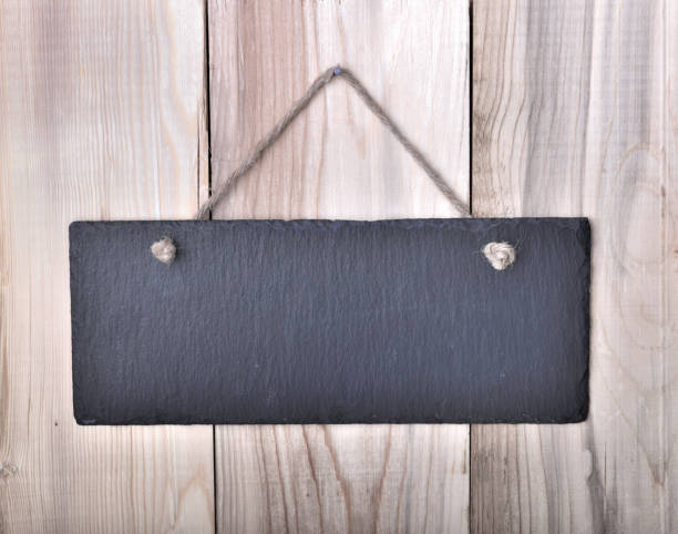 istock little slate hanging by a string on a wooden plank 1129643296
