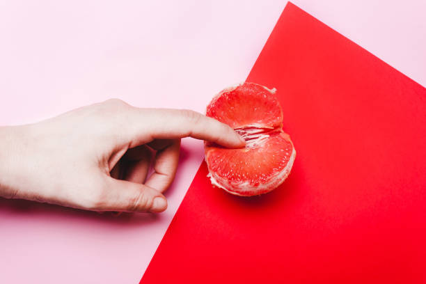 concept sex, masturbation. hand, fingers in grapefruit - orgasm imagens e fotografias de stock
