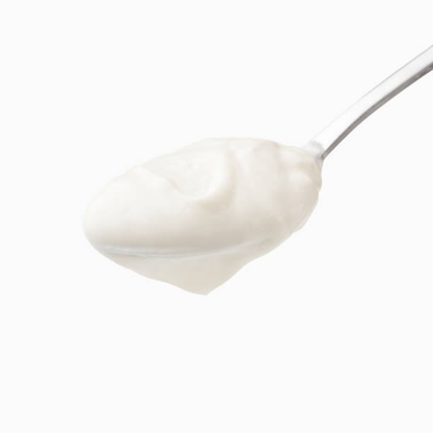 istock Sour cream in spoon isolated 1129644887