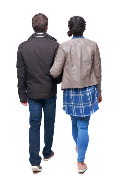 istock Back view of interracial going couple. walking friendly girl an 1129645301