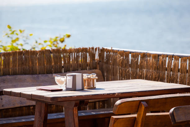 istock wooden restaurant table by the sea 1129645559