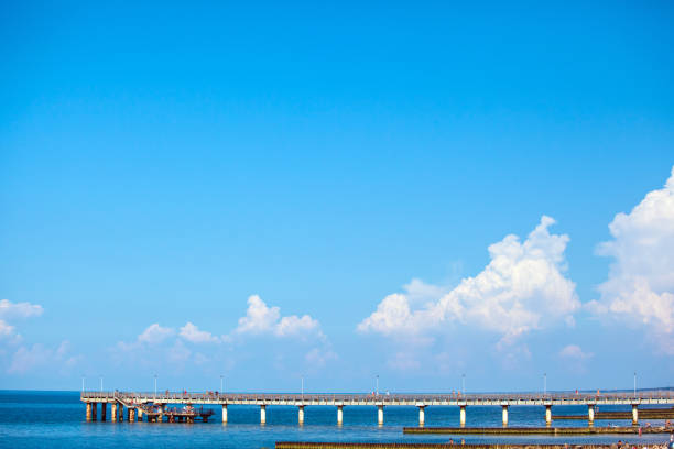istock people walk on a long sea pier on a sunny day 1129645564
