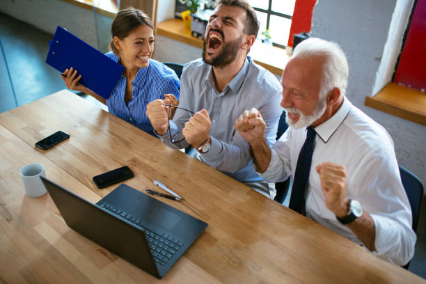 istock Cheerful business team celebrating their success 1129646236