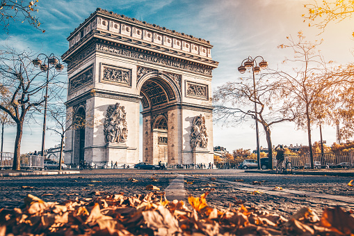 Arc de Triomphe located in Paris, in autumn scenery.