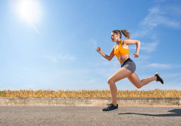 istock Beautiful female athlete running fast in nature 1129646631