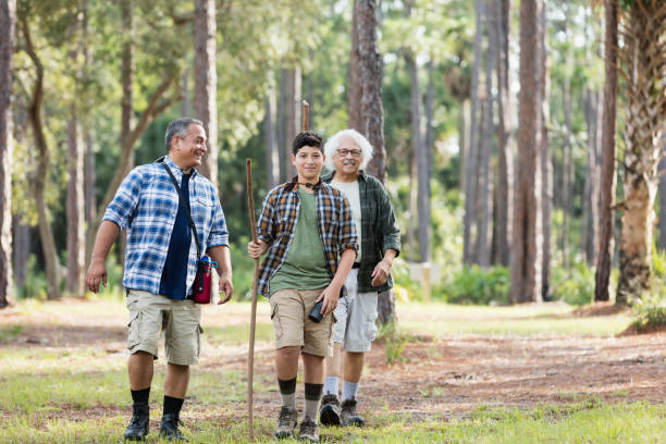 istock Multi-generation Hispanic family hiking in woods 1129646713