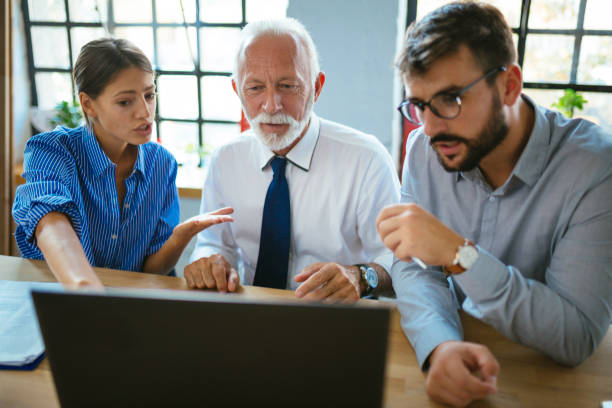 istock Three business people having a meeting at the modern office 1129646868