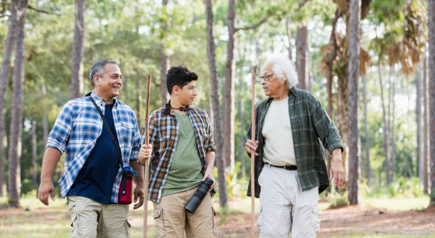 istock Multi-generation Hispanic family hiking in woods 1129646906