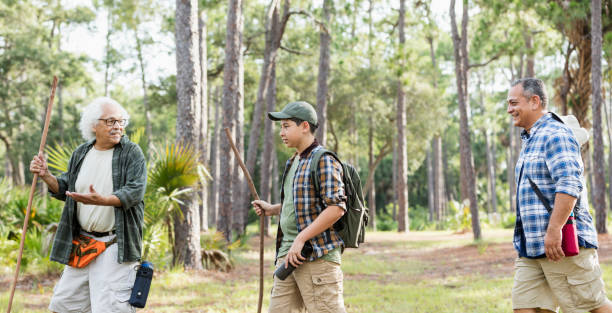 istock Multi-generation Hispanic family hiking in woods 1129646907
