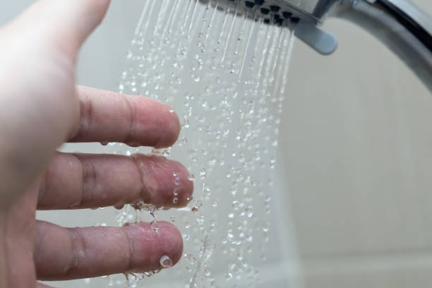 istock hand in the shower test water temperature 1129648052