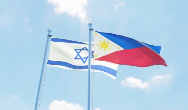 istock Philippines and Israel, two flags waving against blue sky 1129648145