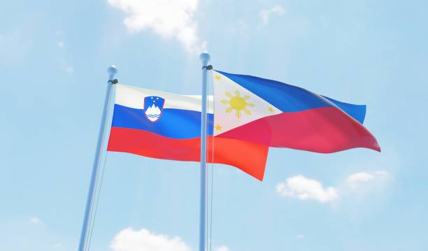 istock Philippines and Slovenia, two flags waving against blue sky 1129648380