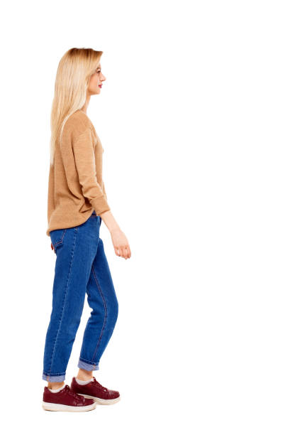 istock side view of walking woman. 1129648407