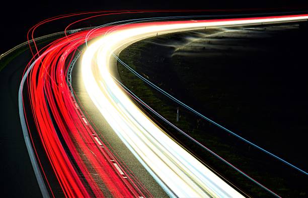 istock lights of cars with night 1129648422