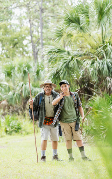 istock Hispanic boy hiking with grandfather 1129648439