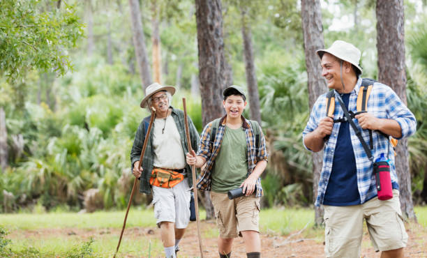 Multi-generation Hispanic family hiking in woods