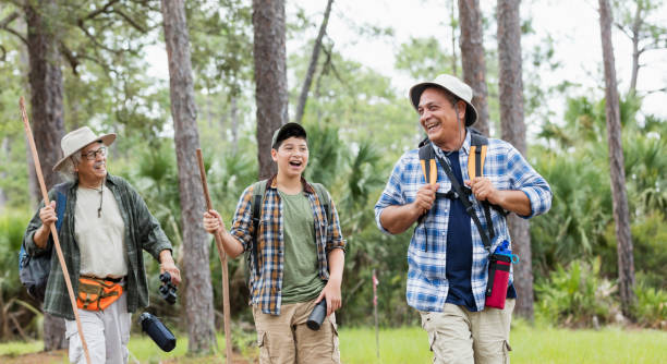 istock Multi-generation Hispanic family hiking in woods 1129648546