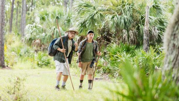 istock Hispanic boy hiking with grandfather 1129648672
