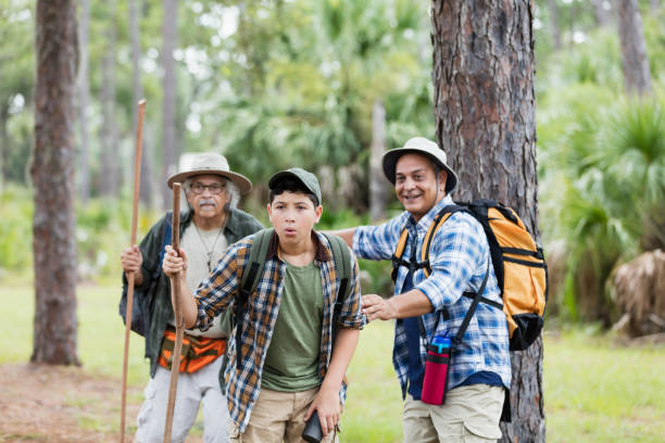 istock Multi-generation Hispanic family hiking in woods 1129648755