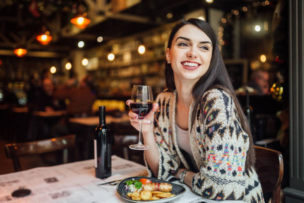 A woman on lunch A woman smiling while drinking wine women only restaurant stock pictures, royalty-free photos & images