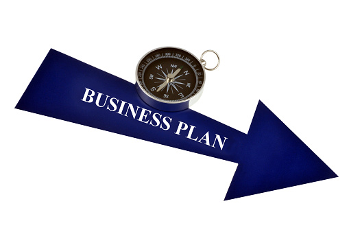 business plan concept with arrow and compass