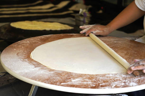 istock Turkish Gozleme. Gozleme is a traditional Turkish dish featuring flat bread stuffed with a range of delicious fillings (cheese, patato, spinach, mince etc.) . Baked on sheet iron. 1129653966