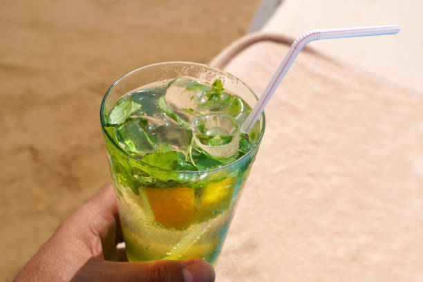 istock Cold mojito drink on the beach sand. 1129654512