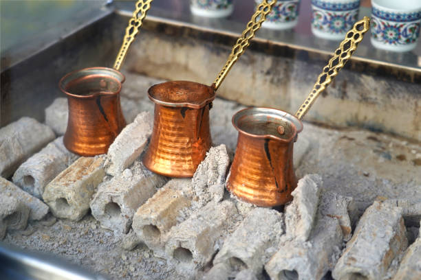 istock Traditional Turkish coffee with copper pot on charcoal fire. 1129654734