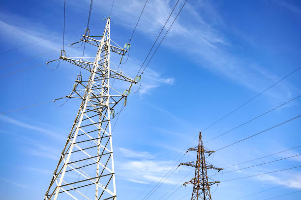 istock Electricity poles with a blue sky on background. Electricity pylon. 1129654793