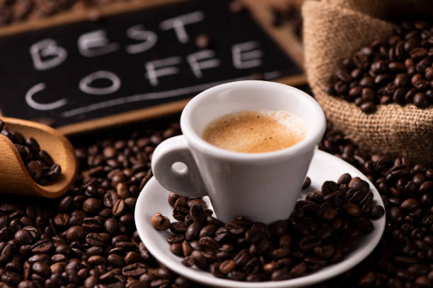 istock Expresso coffee cup close-up over dark roasted coffee beans 1129656073