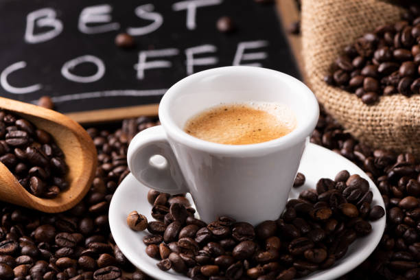 istock Expresso coffee cup close-up over dark roasted coffee beans 1129656120