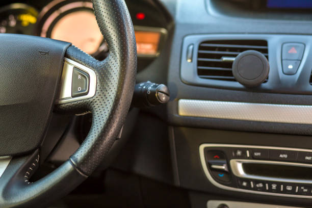 istock Luxurious car interior. Dashboard and steering wheel in black gray color. Transportation, design, modern technology concept. 1129656139
