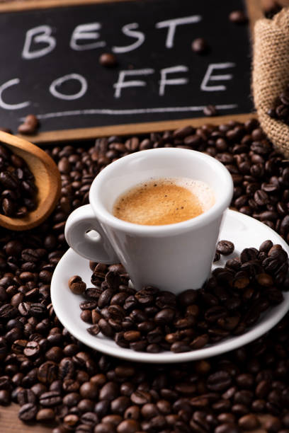 istock Expresso coffee cup close-up over dark roasted coffee beans 1129656740