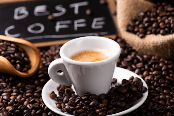 istock Expresso coffee cup close-up over dark roasted coffee beans 1129656760