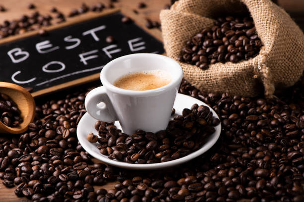 istock Expresso coffee cup close-up over dark roasted coffee beans 1129656989