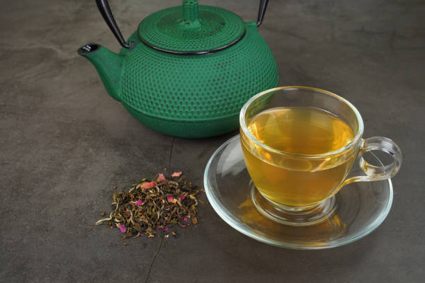 istock White tea with cranberry fruits and cast iron tea pot 1129657178