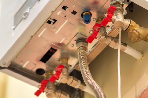 istock Gas water heater boiler for home heating, bottom view. Installation, connection and maintenance concept. 1129659352
